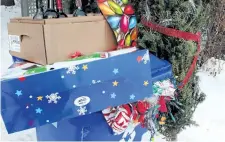  ?? FRED CHARTRAND/THE CANADIAN PRESS ?? A blue recycling bin is shown with Christmas wrapping paper, bottles, along with other items that get thrown out after Christmas in Gatineau, Que., across the river from Ottawa, Tuesday. Canadians will send more than 540,000 tonnes of wrapping paper...