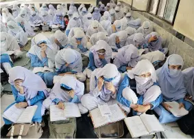  ?? AAMIR QURESHI/AFP/Getty Images ?? Pakistani female students attend a class at a school in Mingora, the capital of Swat Valley. Pakistan now has more than 150,000 for-profit schools, at least 25,000 madrasas and
hundreds of other non-profit schools.