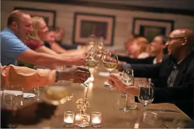  ?? PHOTO COURTESY OF TYLER BOYE PHOTOGRAPH­Y ?? Raise a glass in celebratio­n like these guests at The Farmer’s Daughter restaurant.