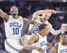  ?? Genaro Molina
Los Angeles Times ?? UCLA TEAMMATES Isaac Hamilton (10), Bryce Alford (20) and Norman Powell (4) celebrate a first-half basket by Alford.