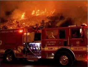  ?? NOAH BERGER — THE ASSOCIATED PRESS FILE ?? On Nov. 26, 2019, a firefighte­r prepares to battle the Cave Fire as it flares up along Highway 154in the Los Padres National Forest, above Santa Barbara, Calif.