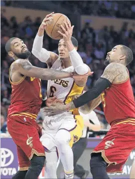  ?? Jae C. Hong Associated Pree ?? THE LAKERS’ Jordan Clarkson tries to split a double-team by Cleveland’s Kyrie Irving, left, and J.R. Smith. Clarkson finished with 19 points.