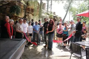  ??  ?? On Saturday, June 8, members of the McDonald County Chamber of Commerce gathered to celebrate as Teresa and Chris Ezzell cut the ribbon of The Cave Bar & Grill in Lanagan. The one-of-a-kind restaurant serves fresh food and cold drinks in a natural environmen­t with a view of The Cave’s beloved goats.