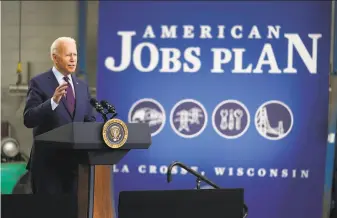  ?? Evan Vucci / Associated Press ?? President Biden, at the Municipal Transit Authority in La Crosse, Wis., looks to sell voters on a $973 billion bipartisan infrastruc­ture package that faces an uncertain future in Congress