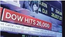 ?? RICHARD DREW/AP ?? A TV screen on the floor of the New York Stock Exchange headlines the Dow Jones topping 26,000 for the first time Tuesday.
