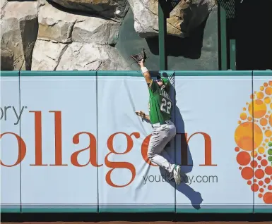  ?? Jayne Kamin-Oncea / Getty Images ?? A’s center fielder Ramón Laureano steals a home run from the Angels’ Brian Goodwin in a game on Aug. 12.