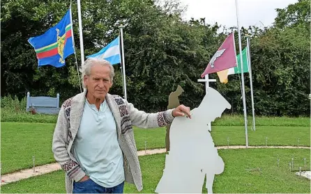  ??  ?? Above, Tom Mulcahy, 72, has built a memorial to all the world’s war veterans. Flags are flown on rotation at the memorial in Norton St Philip while the helmets and sand, left, are a tribute to the Normandy landings