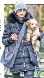  ??  ?? Julianna Margulies has a new doggie! She totes the pup around Washington Square Park on Monday.