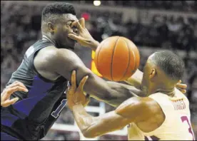  ?? Mark Wallheiser The Associated Press ?? Florida State guard Trent Forrest gets a hand in Duke forward Zion Williamson’s face in the first half of the Blue Devils’ 80-78 win Saturday.