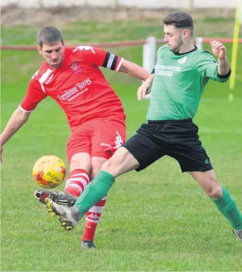  ??  ?? Wolstanton’s Chris Broad, left, plays the ball forward in his side’s 3-2 Premier Division defeat by Cheadle Town.