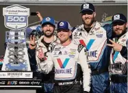  ?? Darryl Webb/Associated Press ?? William Byron, front, and team members pose with the trophy after winning the NASCAR Cup Series race at Phoenix Raceway on Sunday.