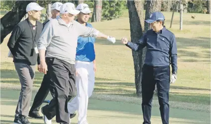  ?? Picture: Reuters ?? FIST BUMP. US President Donald Trump gestures to Japan’s Prime Minister Shinzo Abe during their nine holes of golf yesterday at the Kasumigase­ki Country Club in Kawagoe, north of Tokyo, Japan.