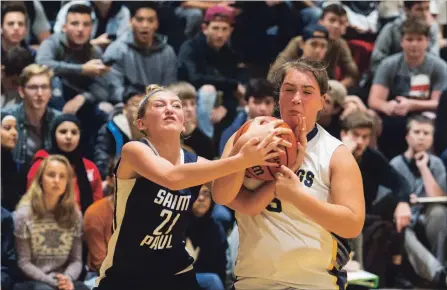  ?? JULIE JOCSAK
THE ST. CATHARINES STANDARD ?? Saint Paul’s Livia Piccirillo, left, and St. Churchill’s Olivia Navar fight for the ball in qualifying-round action at the Standard Girls High School Basketball Tournament Tuesday in St. Catharines.