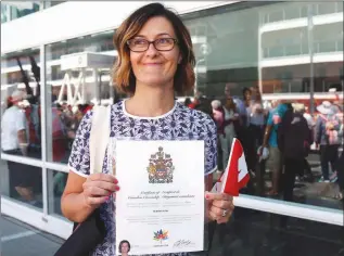  ?? The Canadian Press ?? Byrdie Funk shows off her Certificat­e of Canadian Citizenshi­p outside of a citizenshi­p ceremony at Canada Place in Vancouver on Saturday.
