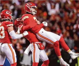  ?? Jeff Roberson/Associated Press ?? Chiefs kicker Harrison Butker gets lifted in the air after his game-winning field goal against the Cincinnati Bengals with 3 seconds left in the AFC Championsh­ip Game in Kansas City, Mo.