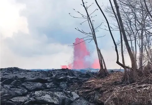  ?? U.S. GEOLOGICAL SURVEY VIA AP ?? This photo from a video Tuesday shows lava from a fissure created shooting up to heights of 200 feet near Pahoa, on Hawaii’s Big Island.