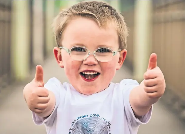  ??  ?? THUMBS UP: Four-year-old Jaxon McLean completed a four-mile walk for Macmillan Cancer Support to say thanks for helping his dad.