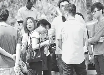  ??  ?? Family and friends of the deceased gather at the Tapah Hospital Forensic Unit. — Bernama photo