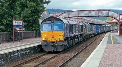  ?? GORDON KIRKBY ?? No. 66304 passes Aviemore on July 13 with the 4D47/13.07 Inverness to Mossend ‘Tesco’ working. Tucked in behind the train loco is Type 3 No. 37069, which had been acting as DRS’s emergency standby loco at Inverness until replaced that day by classmate No. 37419.