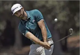  ?? CHRIS O’MEARA — THE ASSOCIATED PRESS ?? Dustin Johnson chips onto the seventh green during a practice round for The Players Championsh­ip.