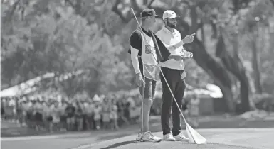  ?? AARON DOSTER/ USA TODAY SPORTS ?? Four days after his second Masters victory, Scottie Scheffler, with caddie Ted Scott, was playing on the PGA Tour in the RBC Heritage. He shot 2-under 69 and was six off the lead.