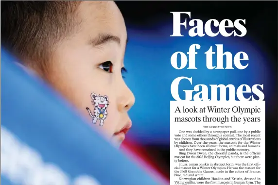  ?? (File Photo/AP/John Locher) ?? A child wears one of the Olympic mascots on his face Feb. 12, 2018, when watching the women’s 1,500-meter speedskati­ng race at the Gangneung Oval at the 2018 Winter Olympics in Gangneung, South Korea.