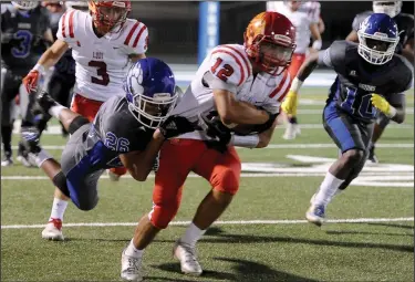  ?? BEA AHBECK/NEWS-SENTINEL ?? Above: Lodi's Andreas Pappas is tackled by Bear Creek's Richard Sagapolu during their non-conference game in Stockton on Friday. Below: Lodi's Niko Cabrera tackles Bear Creek's Quincy Glasper.