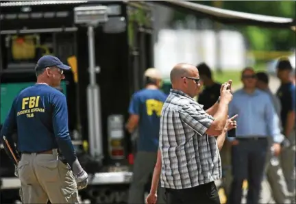  ?? ERIC BONZAR — THE MORNING JOURNAL ?? FBI agents search a wooded area near Mussey Avenue in Elyria on June 21, in connection to missing woman Tierra Bryant of Middleburg Heights.