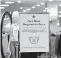  ?? DAVID ZALUBOWSKI/ASSOCIATED PRESS ?? A sign advises shoppers of the need for masks to enter a Macy’s department store in Park Meadows Mall in Lone Tree, Colorado.