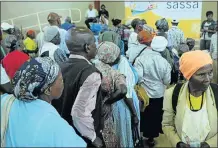  ??  ?? BEHOLDEN TO STATE: Pensioners queue for their grants at the Schoemansd­al Community Hall in Mpumalanga