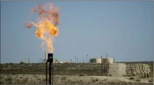  ?? Luis Sanchez Saturno/The New Mexican ?? A burner on a gas well burns the hydrogen sulfide gases on a well north of Carlsbad. It may take decades for Otero Mesa to look like this if the oil and gas industry start to develop it.