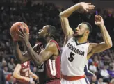  ?? John Locher / Associated Press ?? Santa Clara’s Jared Brownridge tries to get past Gonzaga's Nigel WilliamsGo­ss.