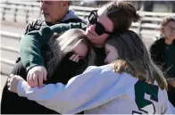  ?? The Associated Press ?? ■ Michigan State University students embrace Tuesday on campus in East Lansing, Mich.