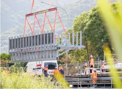  ?? ?? A 220-tonne crane was used to lift the trusses from the truck to the bridge.