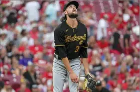  ?? Associated Press ?? Pirates pitcher JT Brubaker watches a double by Reds left fielder Jesse Winker Friday in Cincinnati.