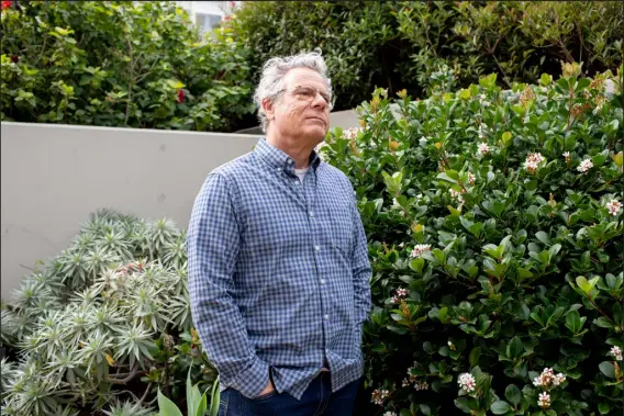  ?? ANNE MOFFAT — SPECIAL TO THE DENVER POST ?? Rick Skanron stands in the garden of his apartment building in Port Melbourne, Australia, on Thursday.