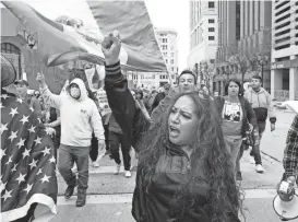  ?? ?? People head down East Wisconsin Avenue during the march for immigratio­n reform in Milwaukee on Sunday.