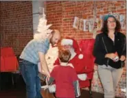  ??  ?? Children got the chance to meet with Santa Claus on Saturday during an event hosted by Feel the Warmth at Steel River Playhouse. The event was aimed at giving toys to children in need.