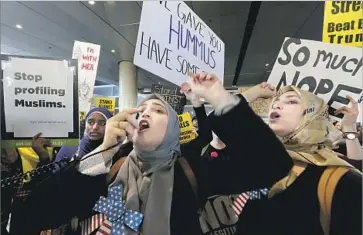  ?? Luis Sinco Los Angeles Times ?? WOMEN PROTEST the travel ban at L.A. Internatio­nal Airport. Although federal Judge James Robart halted the executive order nationwide, the Justice Department said it would appeal his temporary order.