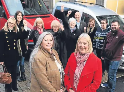  ?? Picture: Kim Cessford. ?? Staff, volunteers and members of the Inclusion Group with their new vehicles and, front from left: Gillan Bayford who donated the buses, and Fiona Flynn, group manager.