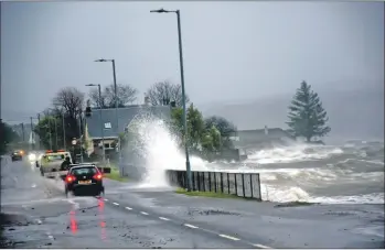  ?? 51_a03StormBr­endan_Ardrishaig­05 ?? Waves crash over the A83 through Ardrishaig.