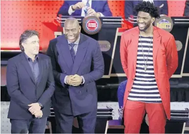  ?? FRANK FRANKLIN II/AP ?? Wyc Grousbeck, Boston Celtics co-owner, left, Magic Johnson, president of basketball operations for the Los Angeles Lakers, and Joel Embiid, of the Philadelph­ia 76ers, react after learning their teams will pick 1, 2 and 3 in the June NBA draft.