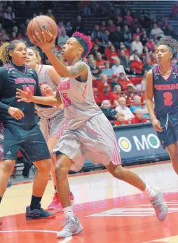  ?? JIM THOMPSON/JOURNAL ?? New Mexico’s Aisia Robertson drives to the basket during Saturday’s game. Robertson had 18 points, 10 assists and six rebounds.