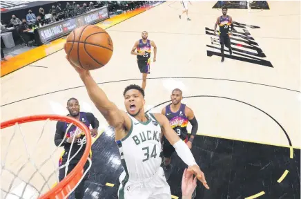  ?? Photo / AP ?? Milwaukee Bucks forward Giannis Antetokoun­mpo rises for another basket in yesterday’s clash with the Phoenix Suns in the NBA Finals.