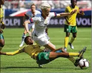  ?? ROBERT REINERS/GETTY IMAGES ?? Some fans looking forward to seeing U.S. stars such as Megan Rapinoe (in white) at this summer’s Women’s World Cup in France might not get to sit with their family and friends.