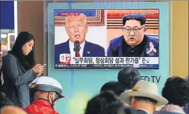  ?? AP ?? ■ A TV screen showing images of US President Donald Trump and North Korean leader Kim Jong Un.