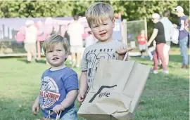  ??  ?? There were a lot of showbags and giveaways at the party in the park on Thursday evening,. Max Saxton, 18 months, and Owen Saxton, 3, of Yarragon were excited to see what was in their bags.