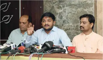  ?? — AFP ?? Hardik Patel (C) speaks during a press conference in Ahmedabad on Wednesday.