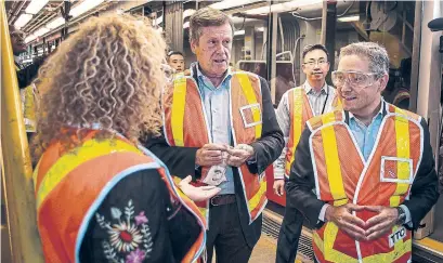  ?? EDUARDO LIMA/STAR METRO ?? Mayor John Tory tours the TTC’s Leslie Barns facility with Minister of Infrastruc­ture and Communitie­s François-Philippe Champagne. Tory says despite disagreein­g with Ford on council cuts, he must work with the premier to improve transit.