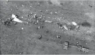  ?? PICTURE: ROBBIE BOTHA ?? SCENE OF THE ACCIDENT: The plane’s wreckage is scattered across the veld. Rescue workers can be seen combing the remains for bodies after the crash that killed president Samora Machel in 1986.